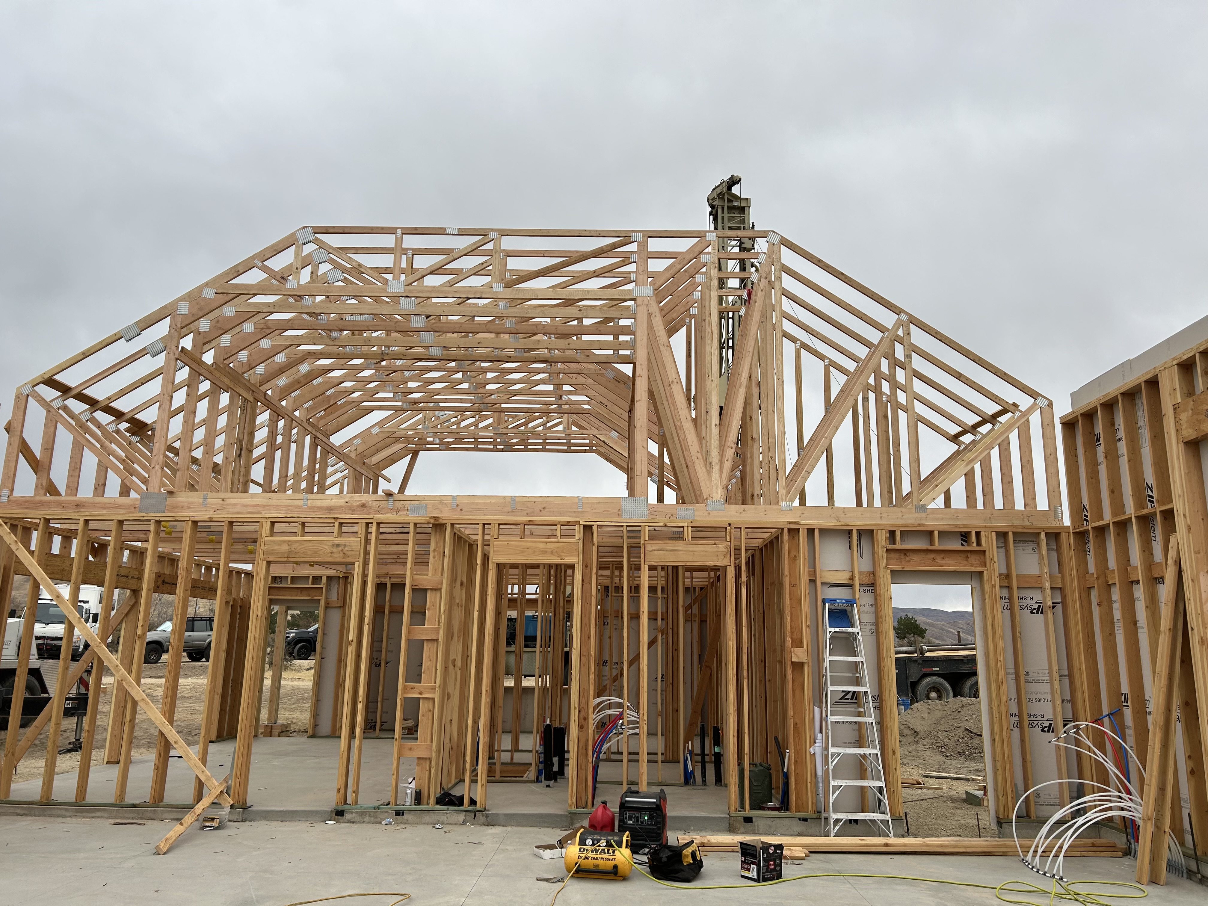 Framed home with large roof trusses and walls in progress