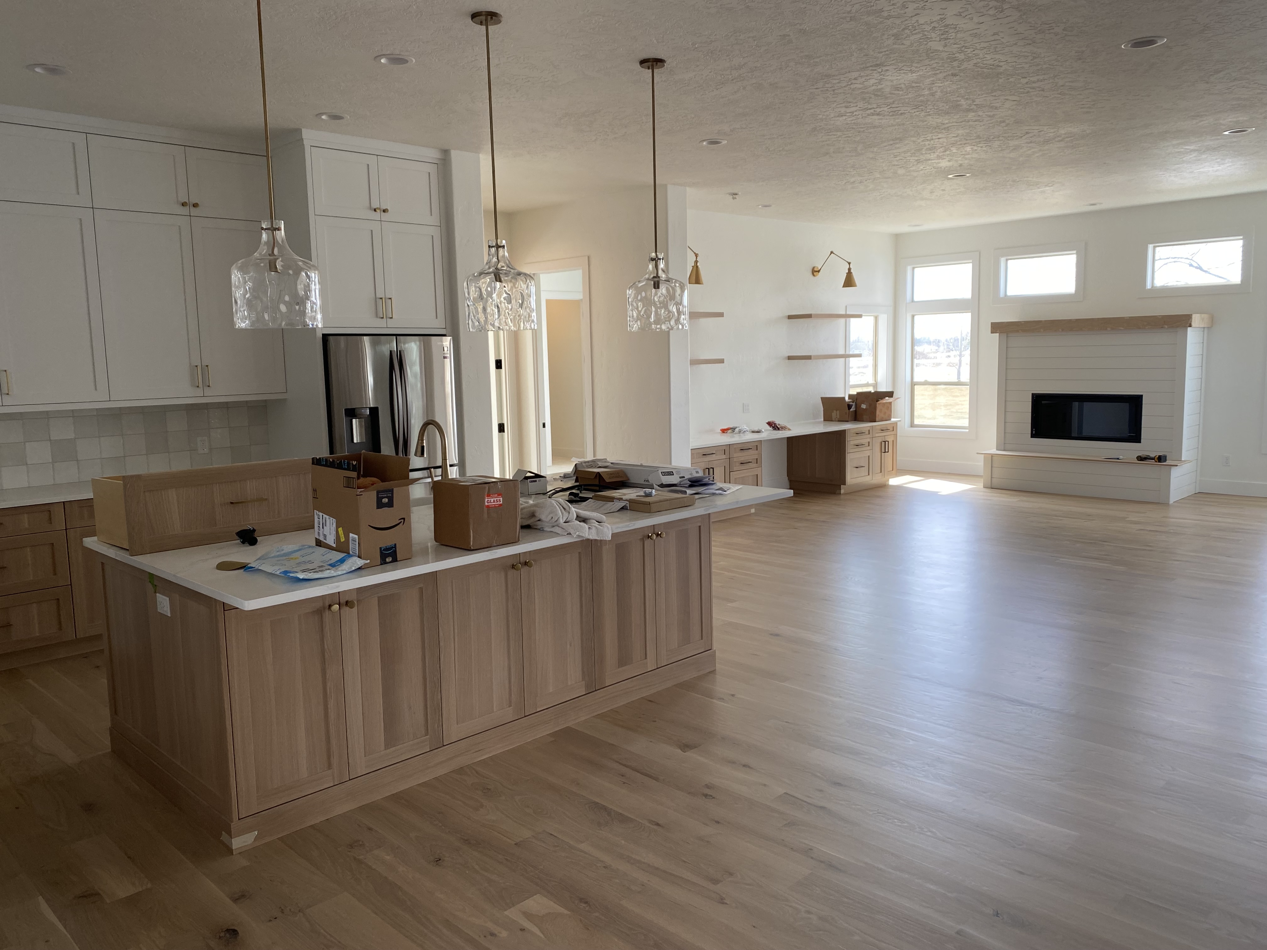 Open-concept kitchen and living room with custom wood island and built-ins