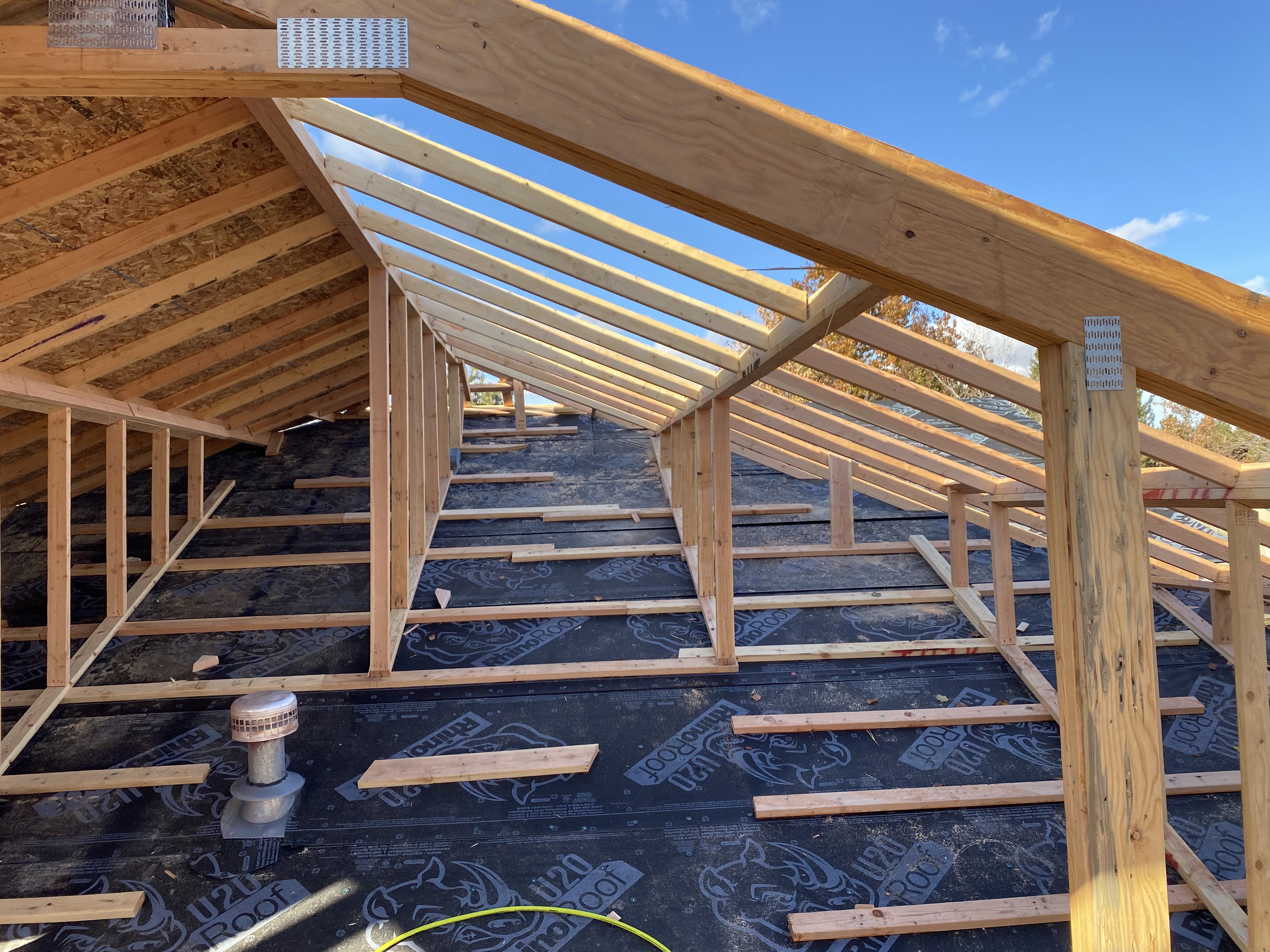 Interior view of roof framing and attic build-out with underlayment